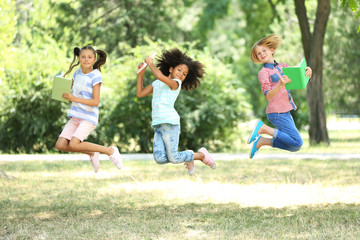 Fototapeta premium Cute kids with books in park