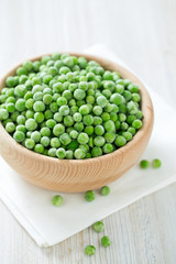 frozem peas on wooden surface