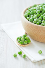 frozem peas on wooden surface