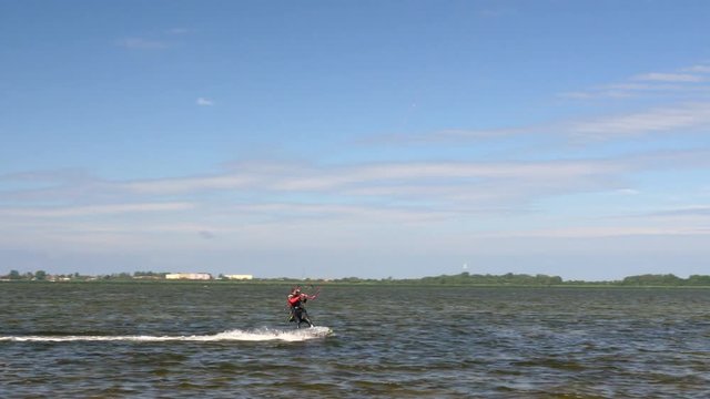 Kite Surfing in Ocean, Extreme summer sport. Kite Boarding in Baltic Sea. Clip contains: kitesurfing, kiteboarding, ruegen, water, surfer, beach	
