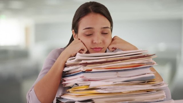 Mexican woman intern overloaded with paperwork