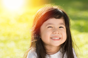 Cute Asian baby Smiling in garden.