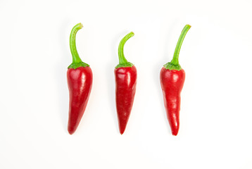 Three ripe red Chilli peppers on white