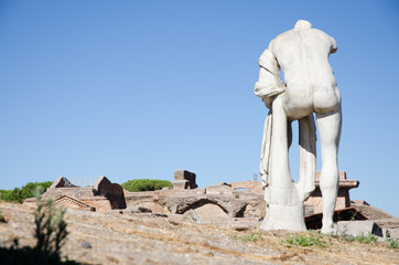 Fototapeta na wymiar Ruins of Ostia antica, Italy. Republican sacred area, statue of Hercules