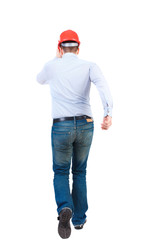 Back view of running engineer in helmet. Walking guy in motion. Rear view people collection. Backside view of person. Isolated over white background. Bearded businessman in a white shirt and a helmet