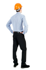 Backview of an engineer in construction helmet stands. Standing young guy. Rear view people collection.  backside view of person.  Isolated over white background. Curly businessman in a light jacket