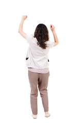 back view of dancing young beautiful  woman. girl  watching. Rear view people collection.  backside view of person.  Isolated over white background. Long-haired curly girl happily waving his hands.