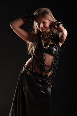 young girl in beads and bracelets on black background