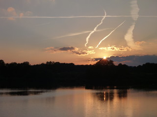 Naklejka na ściany i meble romantic sunset reflected in a lake water