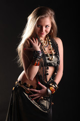 Fototapeta premium young lady with long hair in bracelets and beads