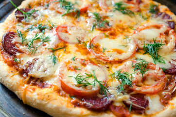 Close up of tasty pizza with chicken, tomato and cheese