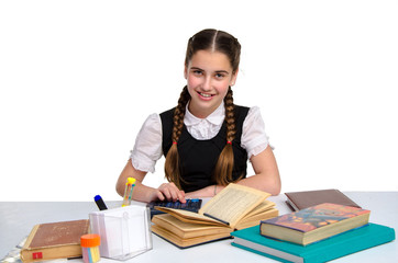 Cheerful young schoolgirl in uniform studying