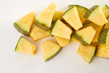 Hamigua Melon cut into slices, Hami Melon, Hami Cantaloupe isolated on white background.