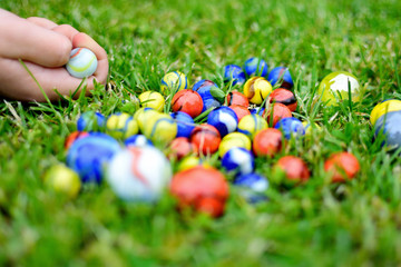 Playing with marble balls. Colorful marbles