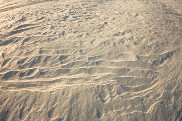 background snow waves at sunset by the wind