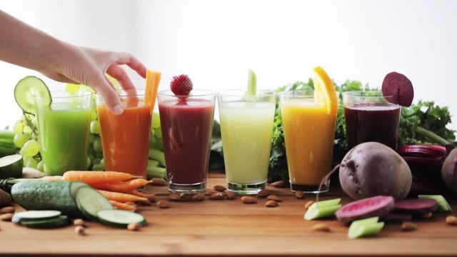 hand putting glass of vegetable juice to table