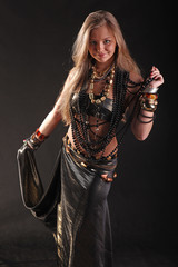 young girl in beads and bracelets on black background