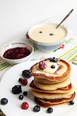 Pancakes with berry, jam and sour cream