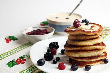 Pancakes with berry, jam and sour cream