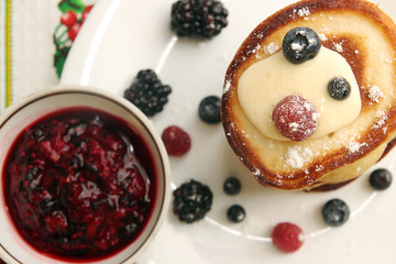 Pancakes with berry, jam and sour cream