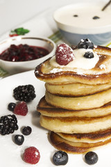 Pancakes with berry, jam and sour cream