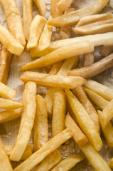 french fries with salt on kitchen paper