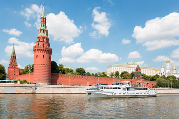 Passenger boat goes across Moscow river in Moscow Kremlin