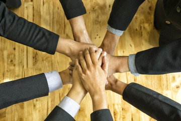 businessman partners in suit showing unity with their hands together