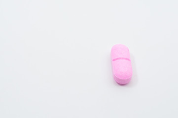 Pills and capsules on white background
