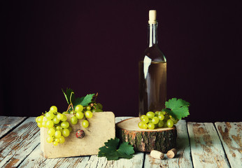 Bottle of white wine and grape