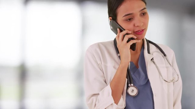 Mexican woman doctor talking on smartphone