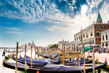 Fototapeten Gondolas on Canal Grande with Basilica di Santa Maria della Salute in the background in Venice, Italy © gatsi