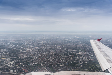Airplane wing in the blue sky with clouds © waewkid