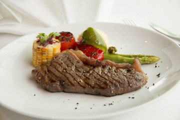  cooked rare sirloin steak  on a white plate