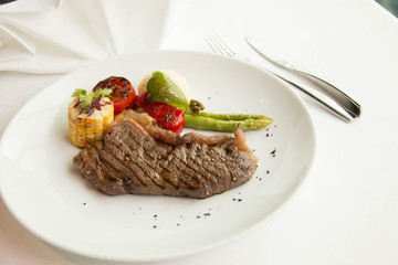  cooked rare sirloin steak  on a white plate