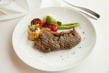  cooked rare sirloin steak  on a white plate