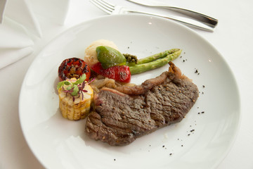  cooked rare sirloin steak  on a white plate