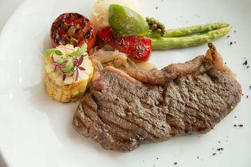  cooked rare sirloin steak  on a white plate