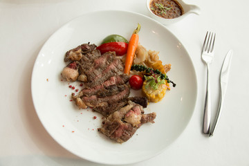  cooked rare sirloin steak  on a white plate