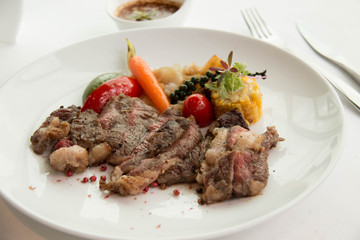  cooked rare sirloin steak  on a white plate