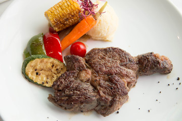  cooked rare sirloin steak  on a white plate