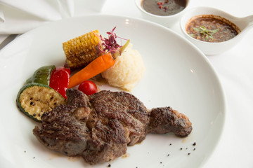  cooked rare sirloin steak  on a white plate