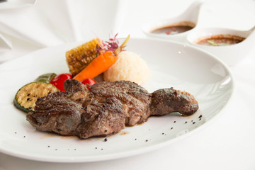  cooked rare sirloin steak  on a white plate