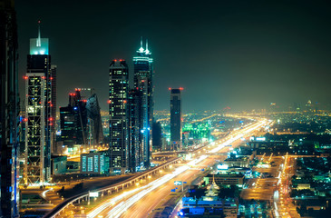 Fototapeta na wymiar Amazing night dubai downtown skyline with tallest skyscrapers and road leading to Abu Dhabi during rush hour, Dubai, United Arab Emirates