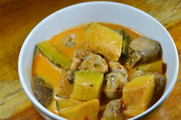 spicy pumpkin with ligament chicken in coconut cream curry on bowl