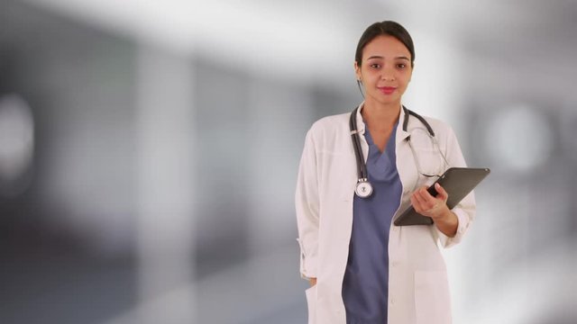Mexican woman doctor smiling holding tablet