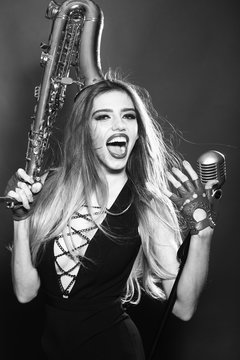 Woman with saxophone and mic