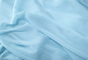 A full page close up of folds of soft blue chiffon fabric texture