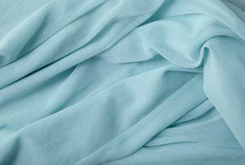 A full page close up of soft blue chiffon fabric texture