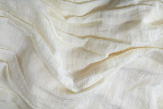 A Full Page Close Up Of Creased Cream Colored Fabric Texture